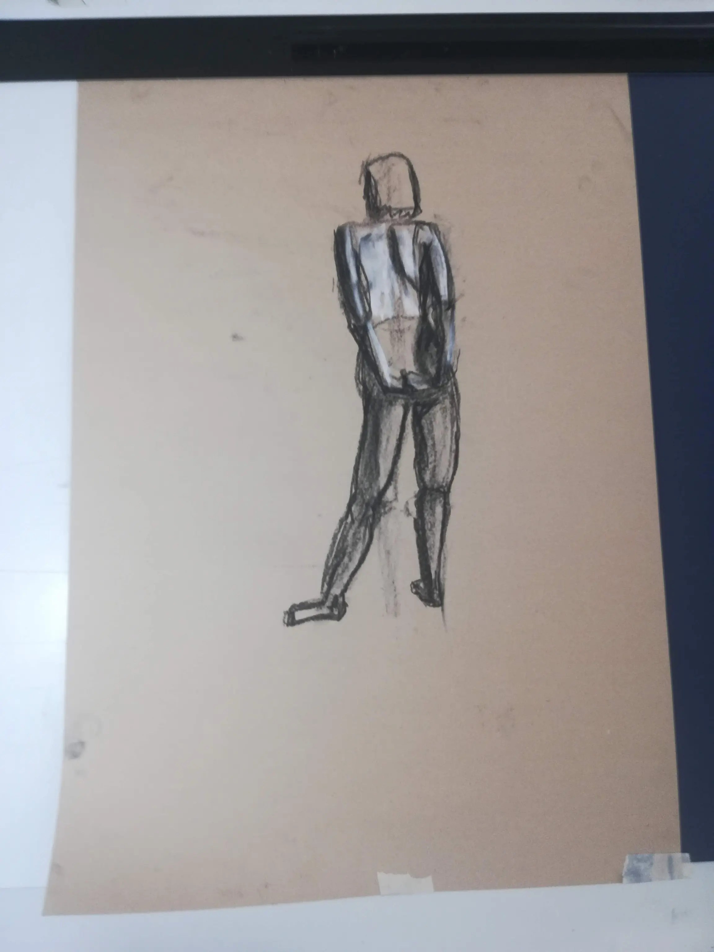Short pose from behind in charcoal